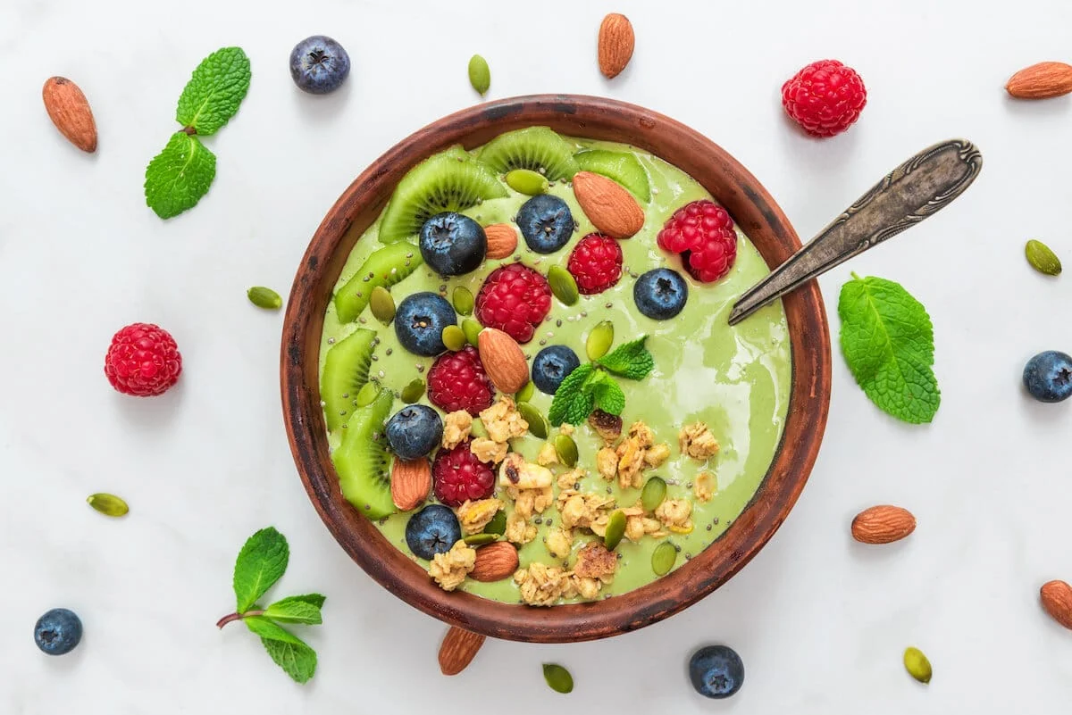 bowl of green smoothie with fruits